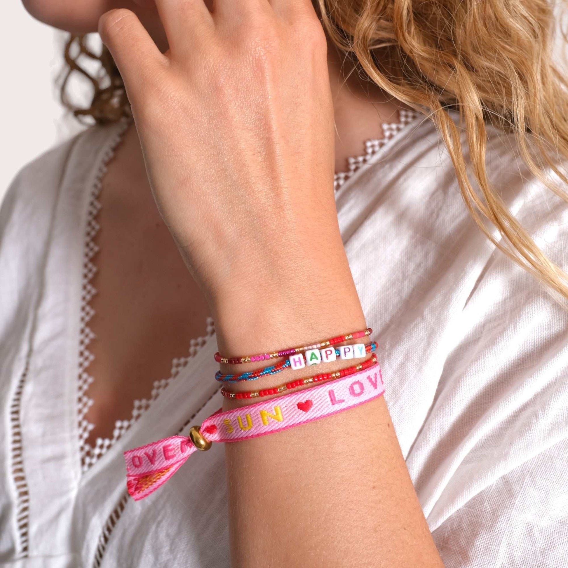 Statement Armband - Sun Lover on wrist, colorful boho style, adjustable, waterproof, perfect for summer and festivals.