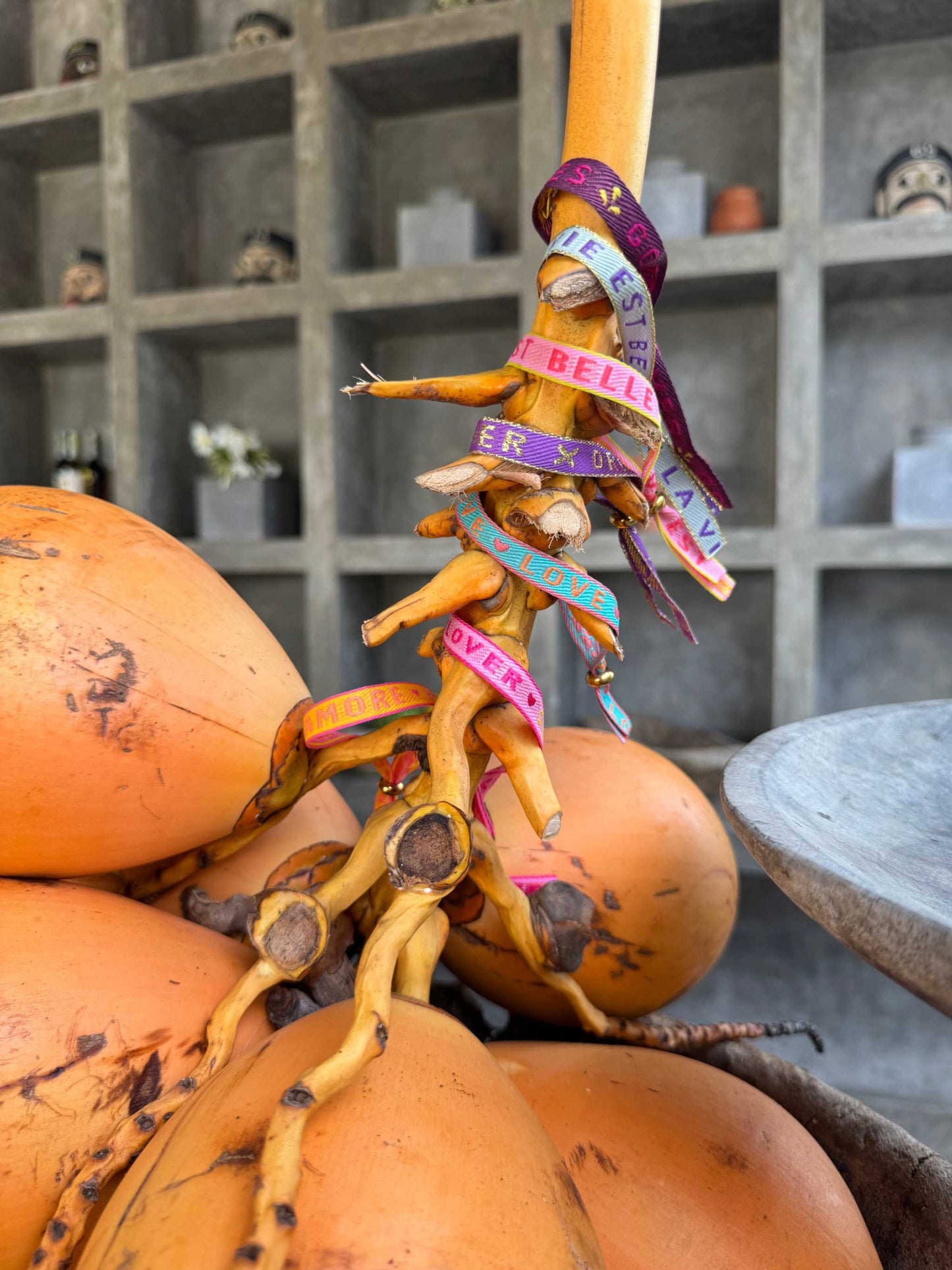 Colorful Statement Armband with uplifting messages wrapped around orange fruit.