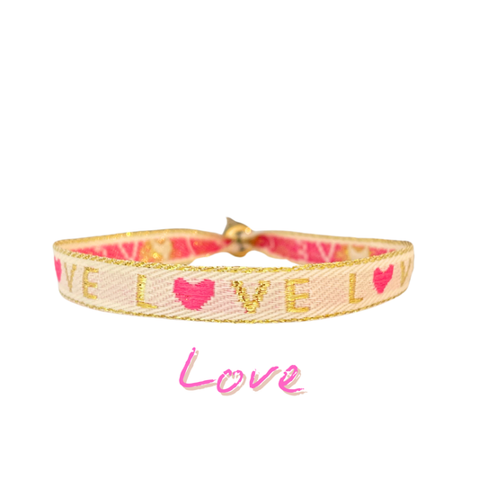 Statement armband in beige, gold, and pink with "Love" text and heart design.
