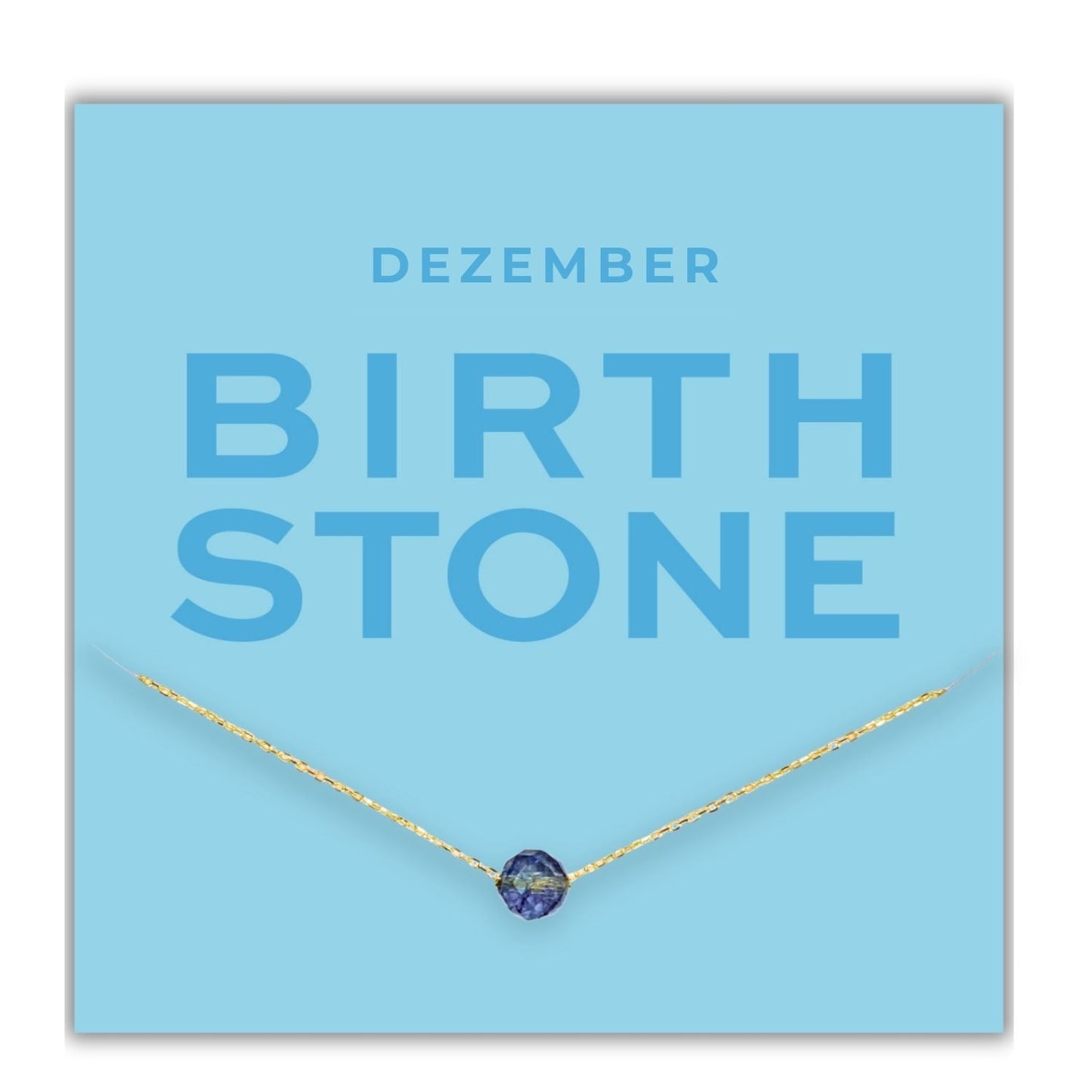 Geburtsstein Kette Dezember, Silberkette mit blauem Topas, auf blauer Karte konfektioniert mit Edelsteinbedeutung.