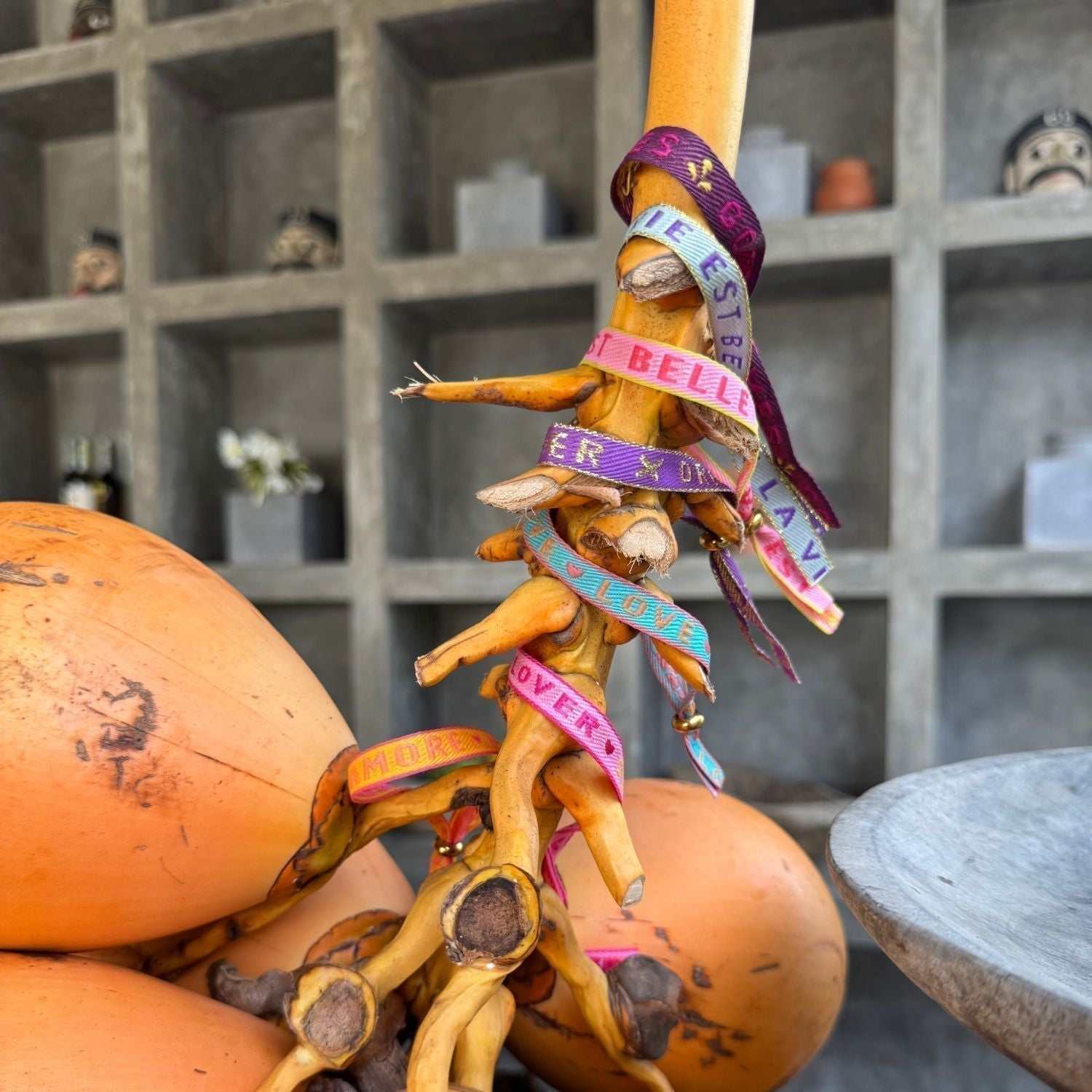 Colorful statement armband with inspirational messages wrapped around a wooden branch display