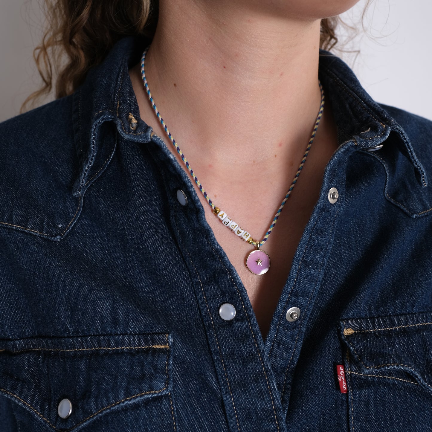 love stoffkette am hals einer frau mit jeanshemd